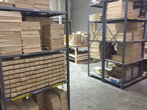 warehouse interior with shelves holding stacks of wood