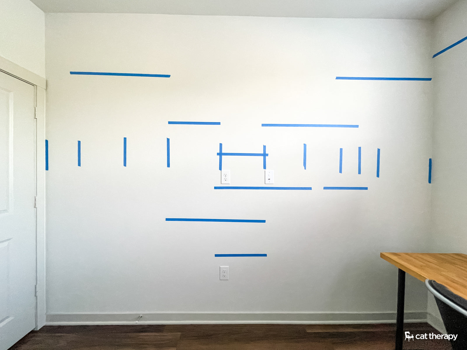 Mock up of cat wall using painters tape to help visualize spacing. 