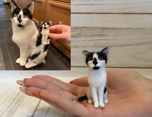 Real cat sitting next to a small felt figure of themselves