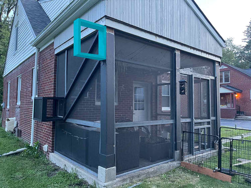 Screened porch attached to a brick house with a blue frame.