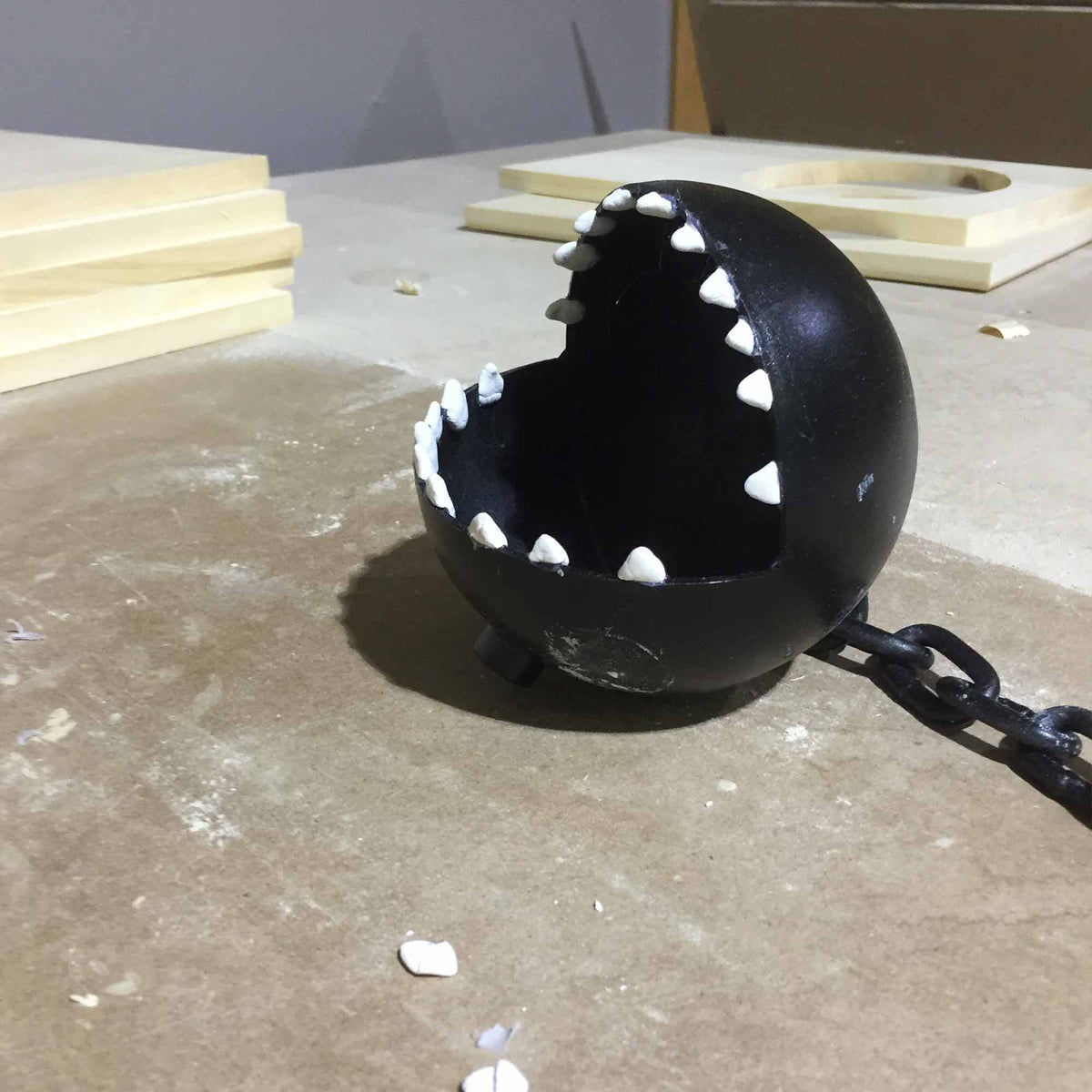 metal sphere with claw teeth made to look like chain chomp