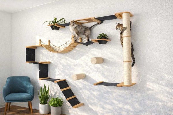 Cat tree with multiple levels and a hammock on a white wall.