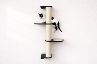 Cat climbing a wall-mounted cat tree with a white background