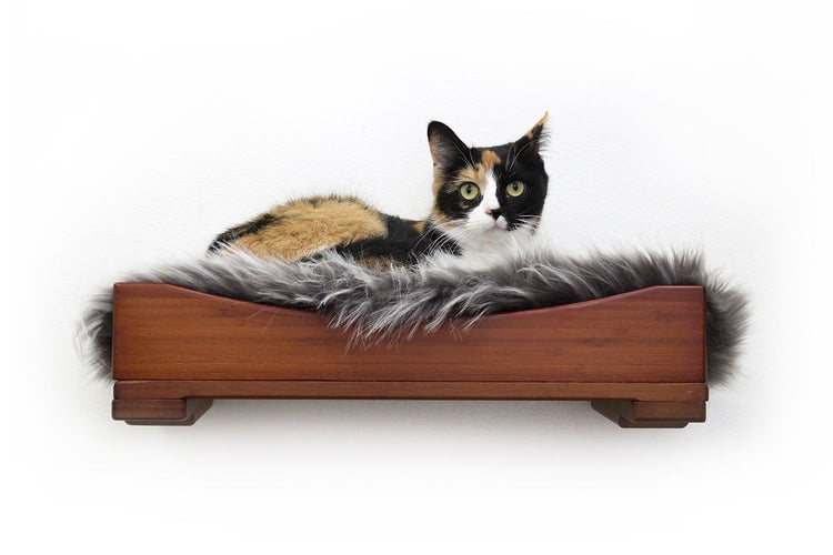 The Nest Bed with a plush pad and a cat