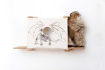 Fluffy cat seated on a Cubby with Ledges, pictured in Natural with Baby Dragon canvas.