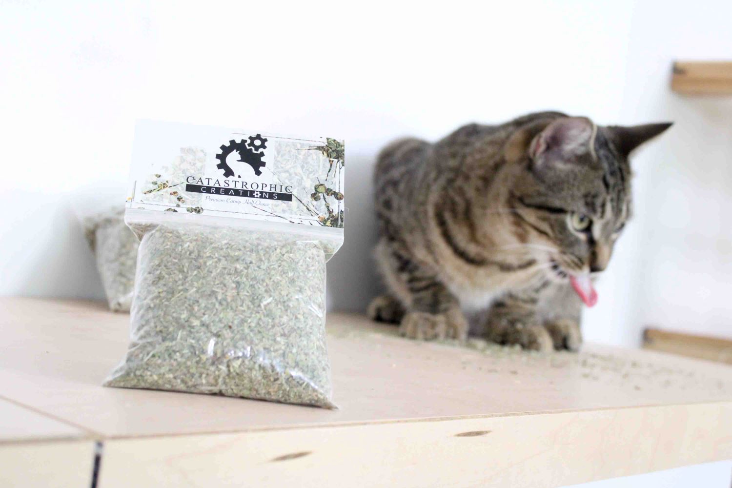close up of premium organic catnip with cat enjoying the product in the background