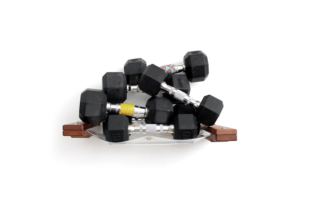 A pile of dumbbells being supported by an Invisible Cat Hammock