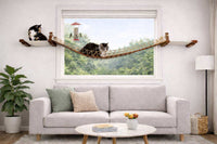 Living room with a cat on a hammock by a window, a gray sofa, and decorative items.