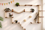 cats climbing on large cat wall tree wearing party hats