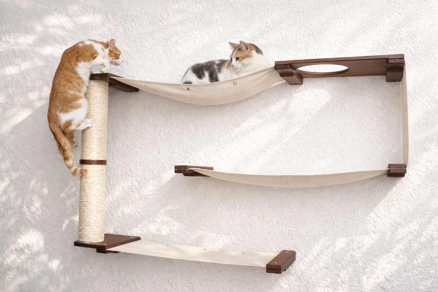 Cat tree with shelves and a scratching post on a white background