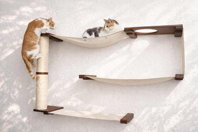 Cat tree with shelves and a scratching post on a white background