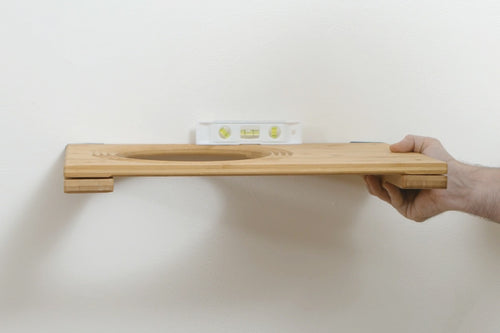 Adjusting Cat Wall Shelf with level to ensure flat installation