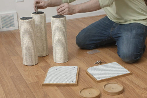 Installing threaded rods into cat scratching pole segments in preparation for mounting on cat furniture.