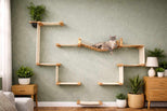 Wooden cat shelf system on a wall with a cat resting on it, surrounded by plants and furniture.